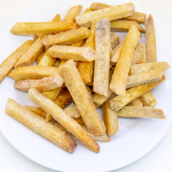 A white plate piled high with golden-brown, crispy taro fries, lightly seasoned.